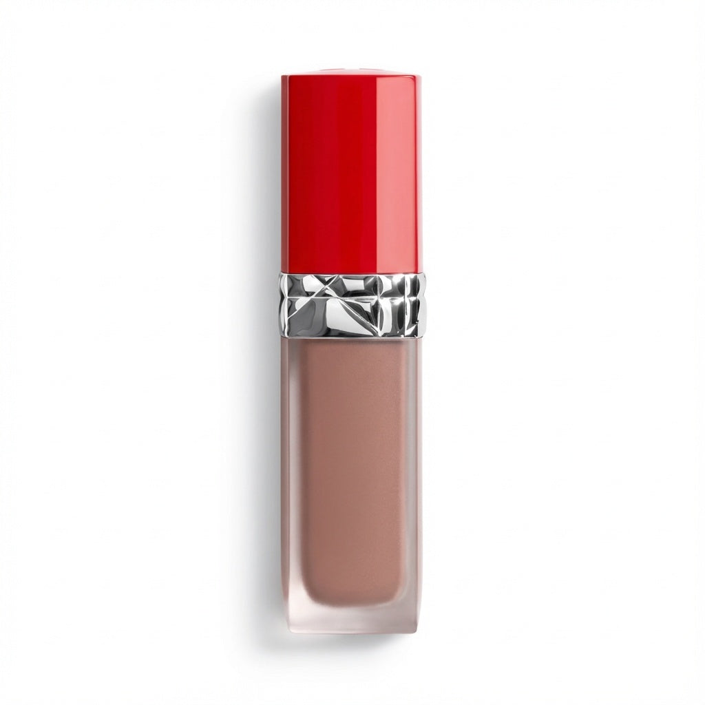 A liquid lipstick in a clear rectangular tube showing a nude pink-brown shade, topped with a glossy red cap and a silver metallic band, set against a plain white background.