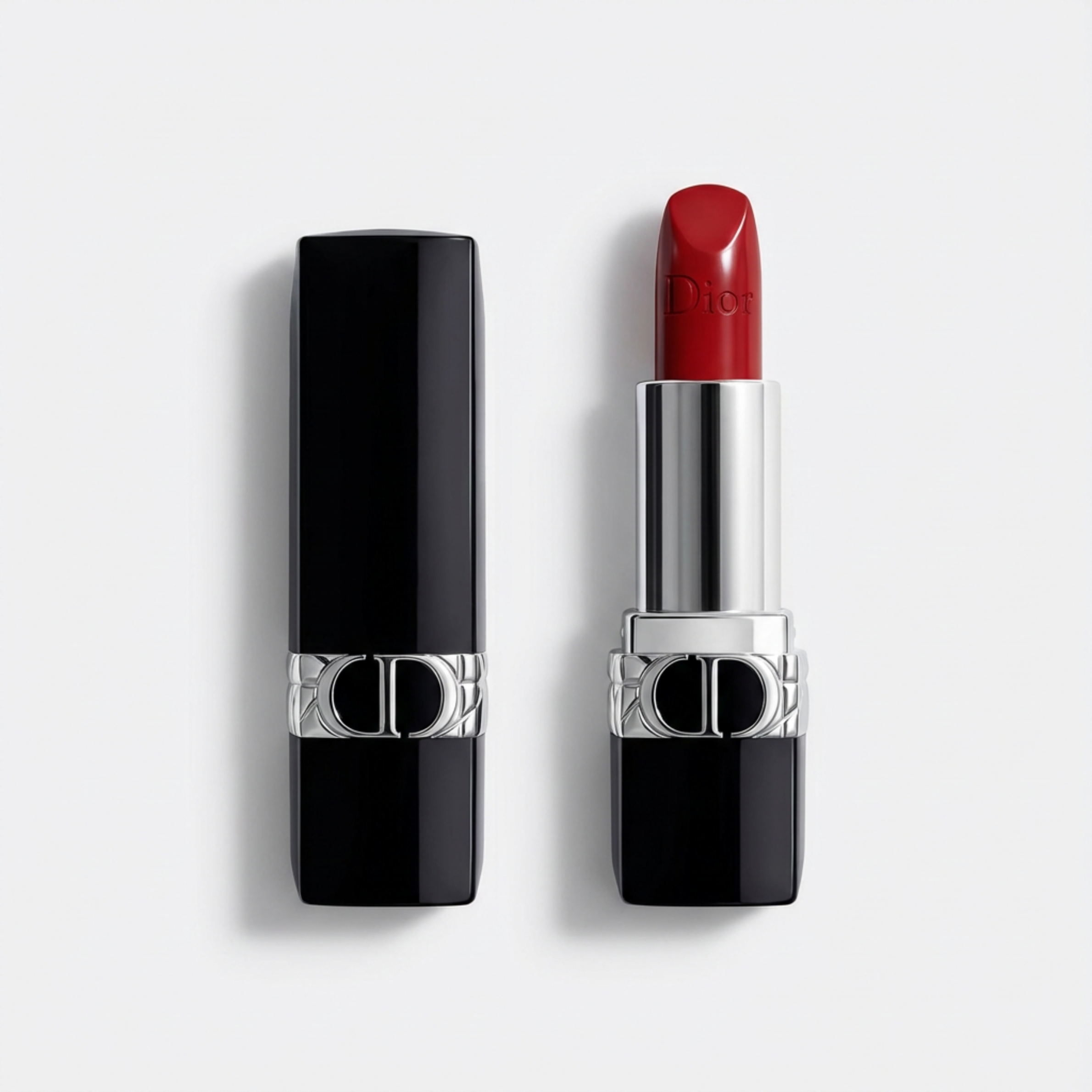 Dior lipstick shown open next to its black cap on a light gray background. The lipstick bullet is a deep red shade, and the tube features a silver collar with the Dior logo.
